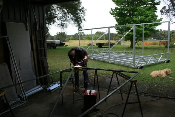 Evan building the first brooder shed at Chicken Caravan