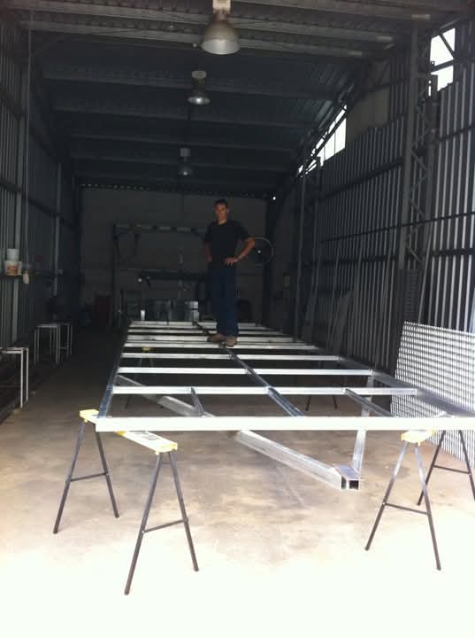 Evan on one of the first frame for a Chicken Caravan being sold