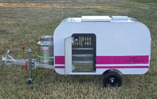 Side view of the Chicken Caravan 10 featured with the door open 