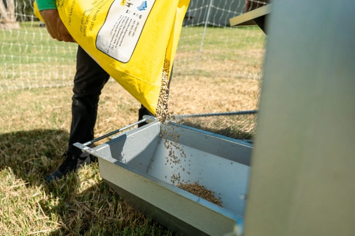 Chicken Caravan 30 feeder being filled up with chicken food