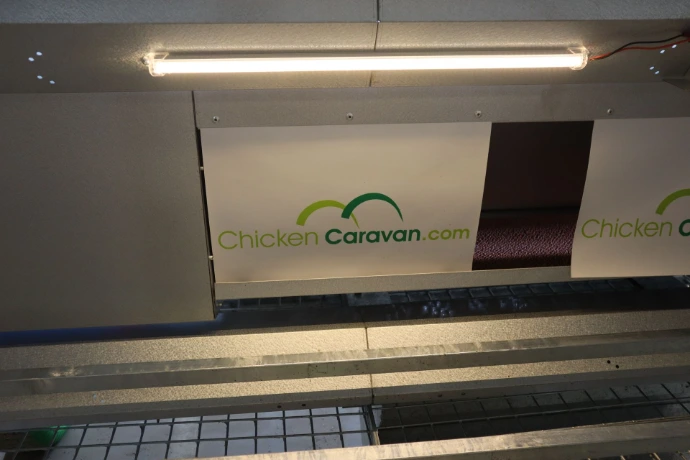 Lighting kit on and installed near the nesting boxes in Chicken Caravan 30